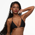 This image features a model sporting a classic black triangle bikini top. The design is minimalistic, emphasizing a sleek and timeless appeal with its simple triangle shape and thin straps.